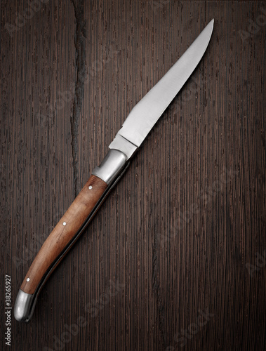 Knife on wooden background