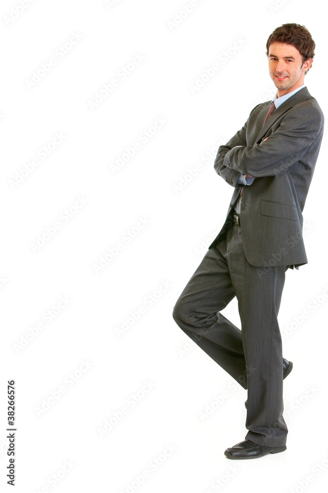 Smiling businessman standing back to imaginary wall Smiling businessman standing back to imaginary wall