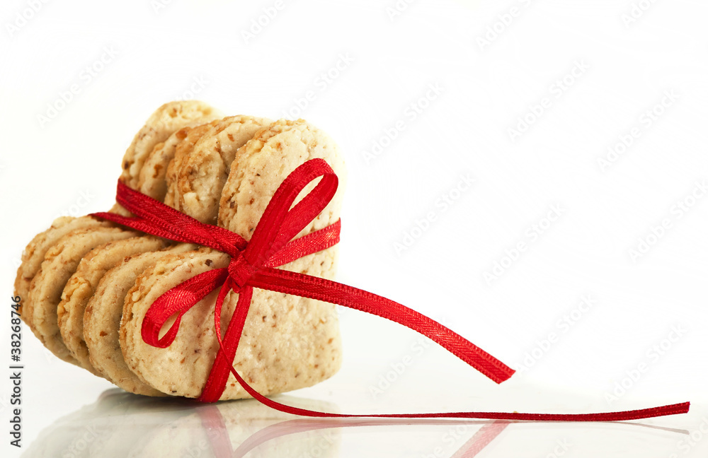Cookies-hearts connected by a red tape on a white background Cookies-hearts connected by a red tape on a white background