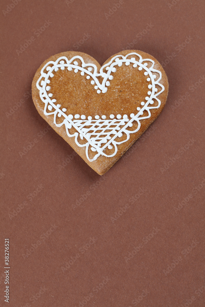 Gingerbread heart on brown background