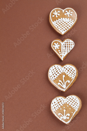 Gingerbread hearts on brown background