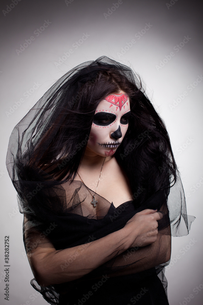 Young woman in day of the dead mask skull face art Young woman in day of the dead mask skull face art