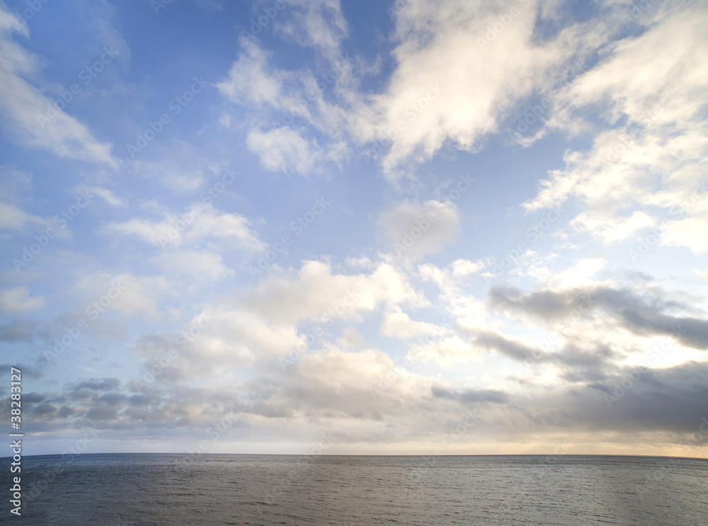 Clouds over dark sea.