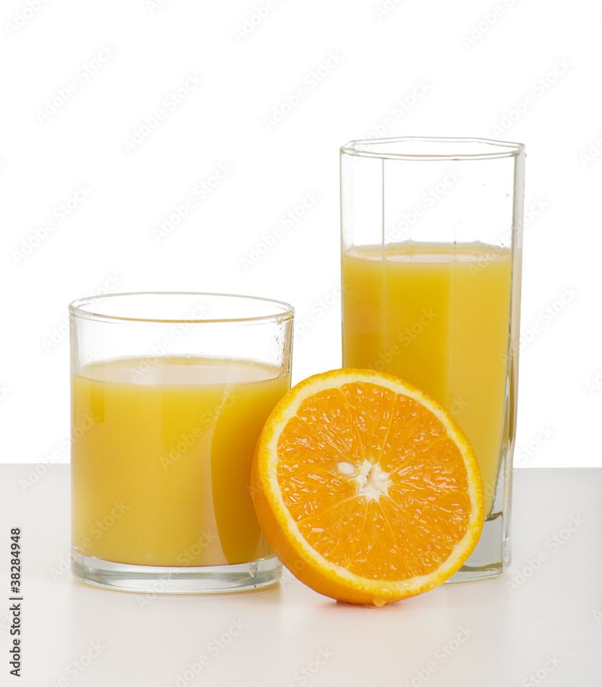 two glasses of orange juice and sliced ripe orange two glasses of orange juice and sliced ripe orange