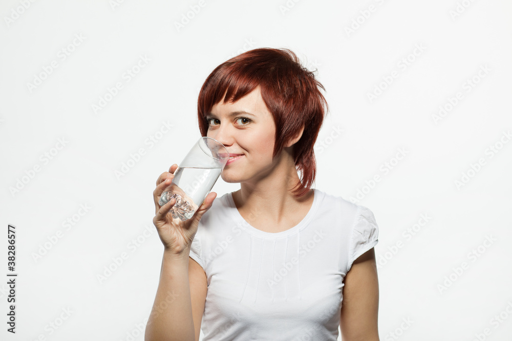 Teenager girl drinking water from glasses Teenager girl drinking water from glasses