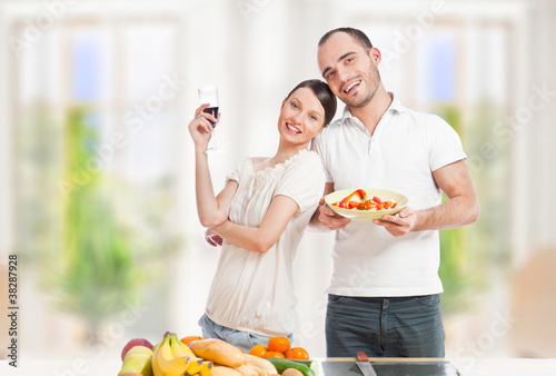 фотографія Lovely romantic couple in casuals enjoying a goodtime in kitchen