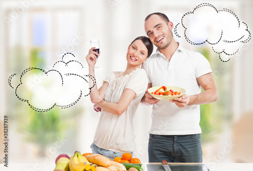 Tableau sur toile Lovely romantic couple in casuals enjoying a goodtime in kitchen