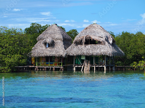 Tropical huts over the water with thatched roof, Caribbean sea, Panama, Central America