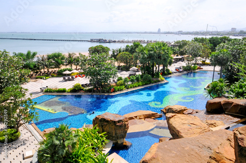 beautiful tropical swimming pool with fountain and view to ocean