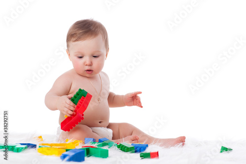 Sweet small baby with toys.