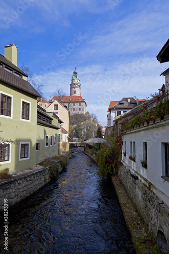 Sunlight lights up building alond a Canal in Krumlov