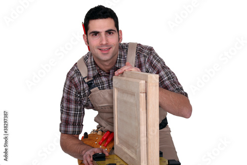 A carpenter working on a closet door. photo