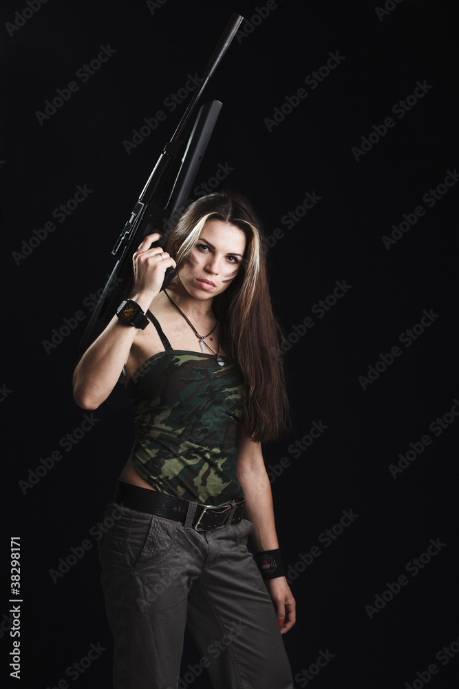 Sexy woman with rifle on dark