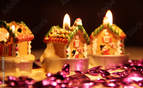 Holiday Candles Surrounded by a Purple Garland