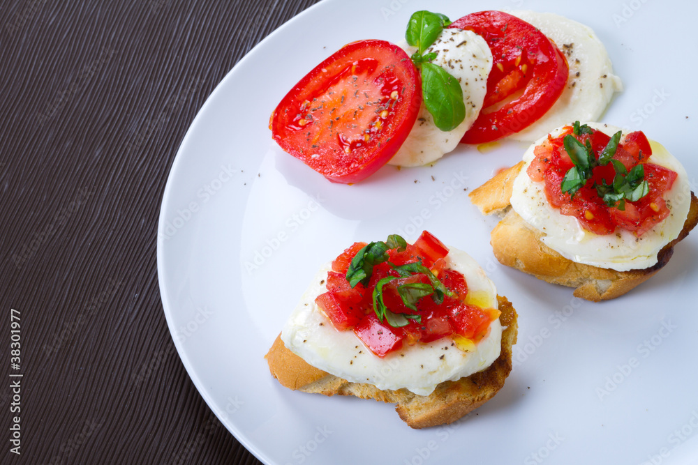 Fresh and tasty bruschetta on white plate Fresh and tasty bruschetta on white plate
