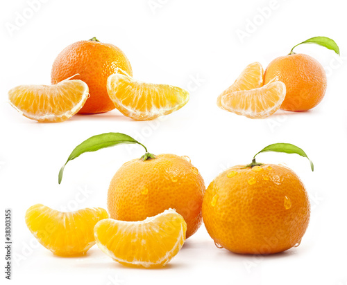 Tangerines with water drops and green leaves