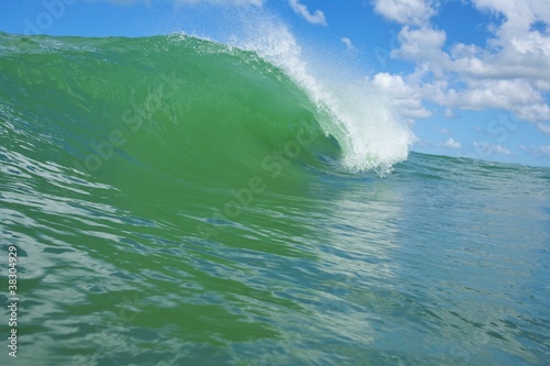 perfect green slab barrel wave breaking outer reef