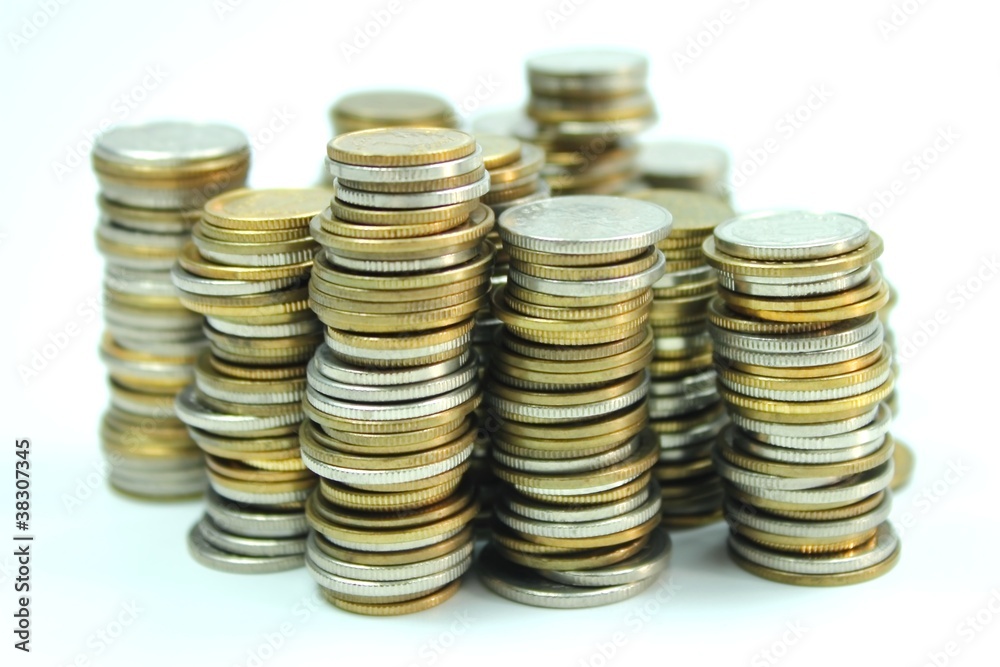 Coins in piles on white background Coins in piles on white background