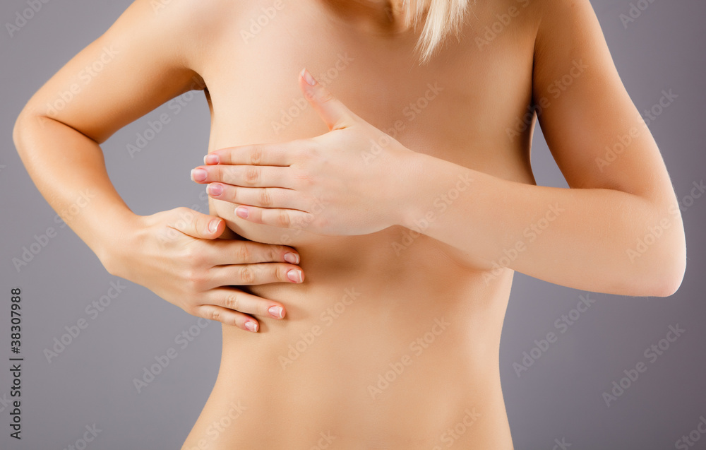 Woman examining her breast Woman examining her breast