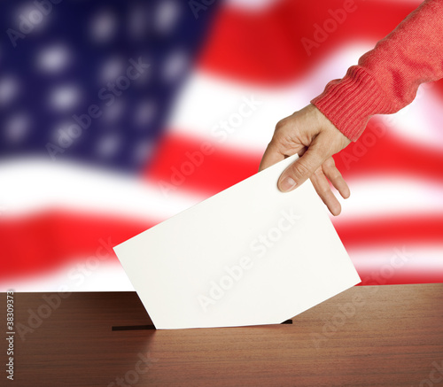 Hand with ballot and box on Flag of USA