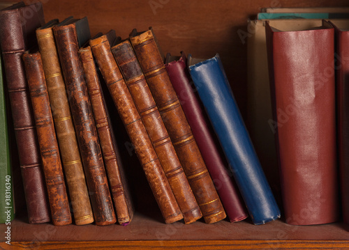 Plakat w ramie Antique books on shelf