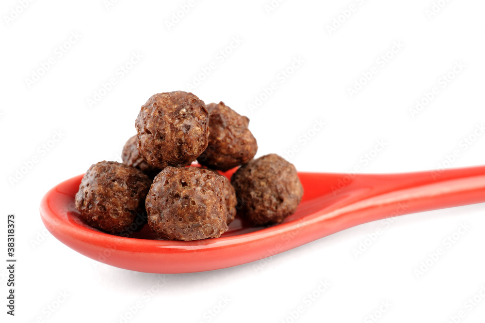 Chocolate corn flakes in spoon isolated on white background Chocolate corn flakes in spoon isolated on white background