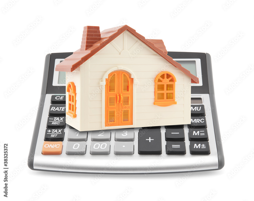 Small orange toy house on calculator Small orange toy house on calculator