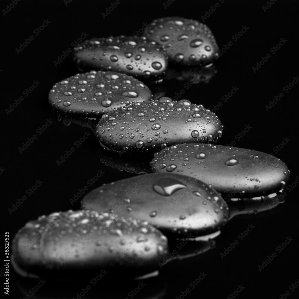 Spa Stones. black shiny zen stones with water drops over black b Spa Stones. black shiny zen stones with water drops over black b