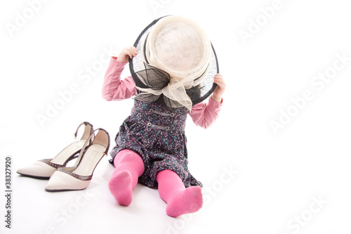 Child playing dress up isolated against white background