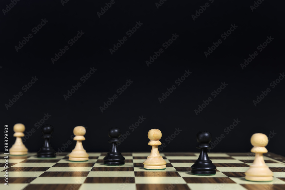 Playing pawns diagonally on a chessboard, black background