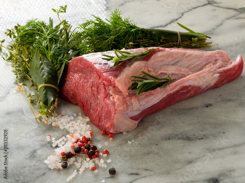 raw tenderloin with  with mixed herbs juniper berr photo