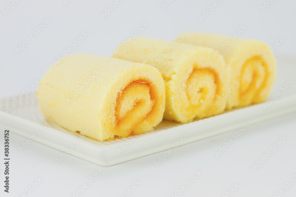 Orange Rolls cake on white plate