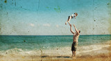 father and son playing together on the beach. Photo in old image