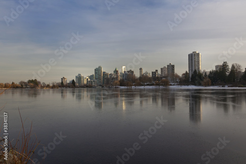 Vancouver  BC skyline reflects over frozen lost lagoon