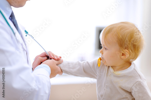 Interested baby stretching for stethoscope