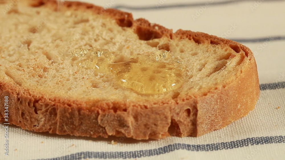 Breakfast - Honey dripping on slice of bread Breakfast - Honey dripping on slice of bread