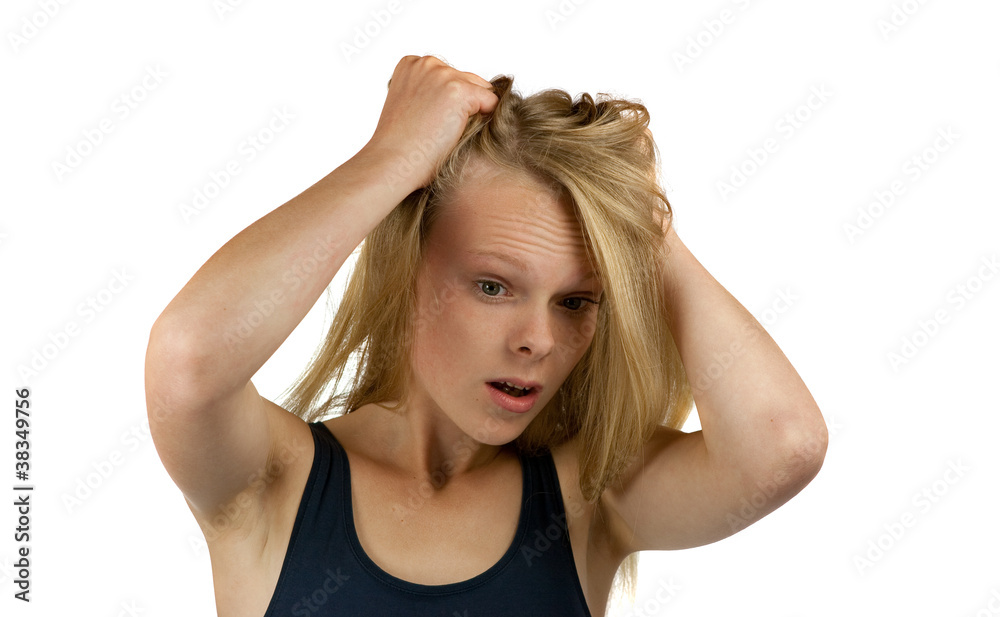 Young woman tearing her hair on white background
