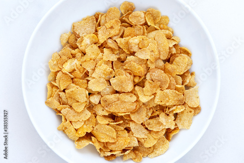 Cornflakes in bowl on white background