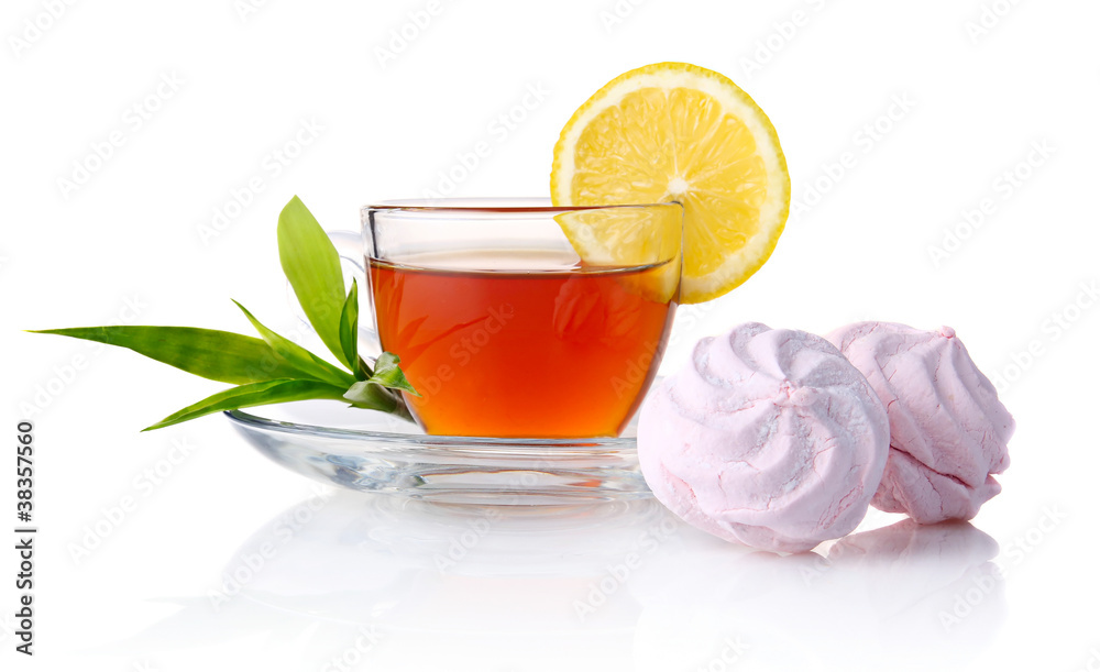 Cup of black tea with lemon, green leaves and marshmallow isolat