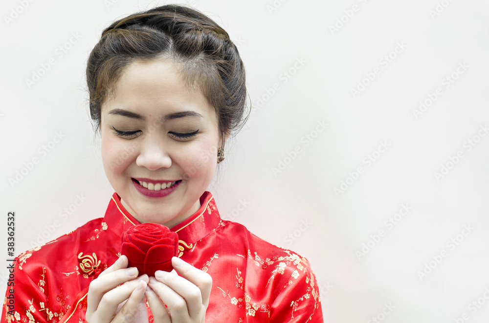 smiling beautiful chinese woman staring at the rose smiling beautiful chinese woman staring at the rose