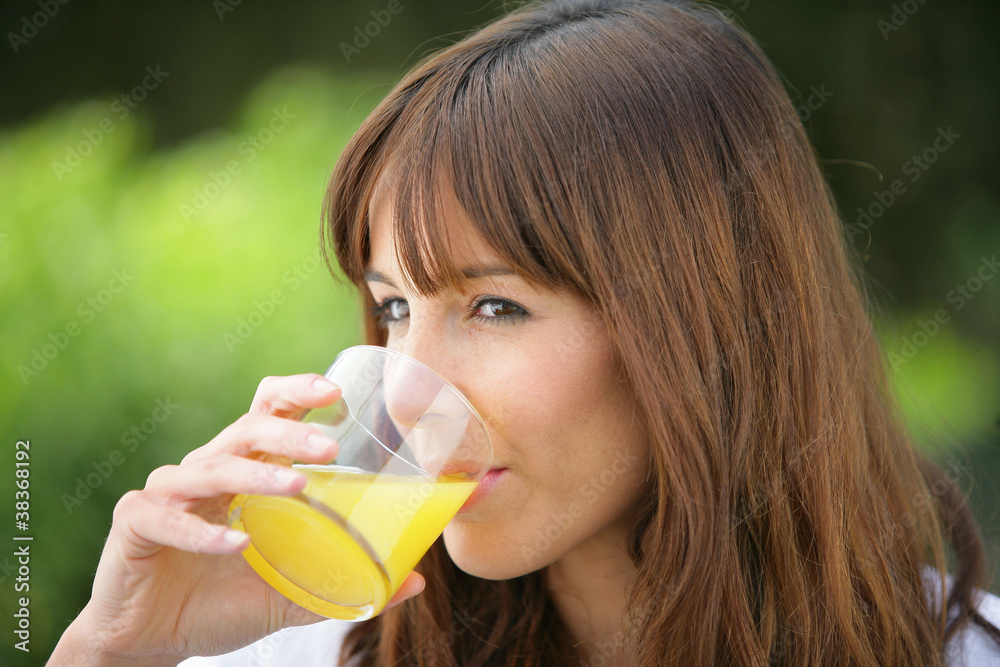 woman drinking fresh orange juice woman drinking fresh orange juice