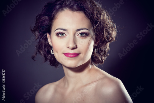 Face of a beautiful brunette girl with curly hair