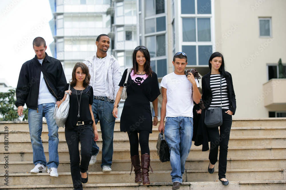Fototapeta premium Young men and young women coming down stairs