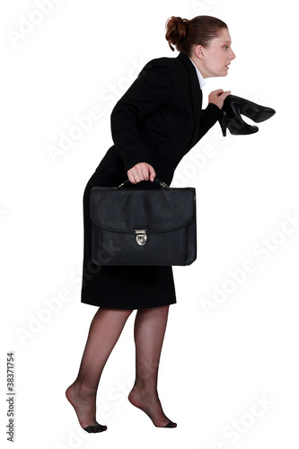 Woman sneaking out of the office