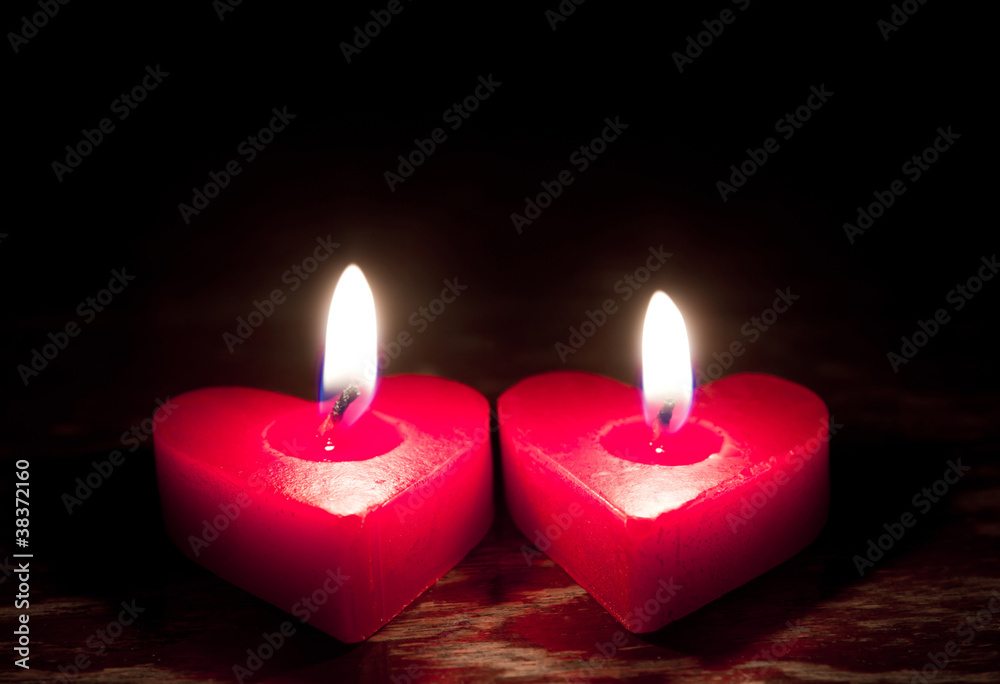 Red burning heart shaped candles Red burning heart shaped candles