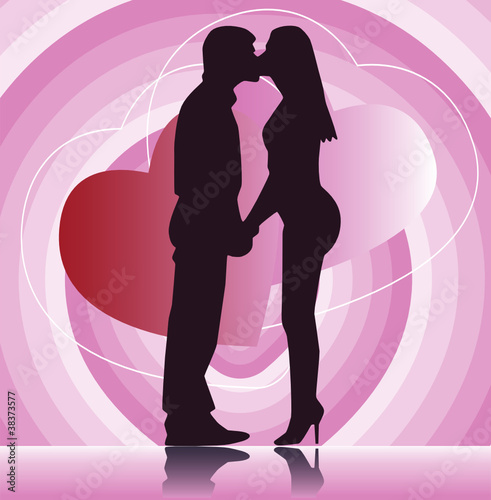 The couple kisses on the pink background.