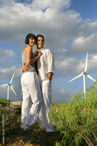 Couple in front of wind farm