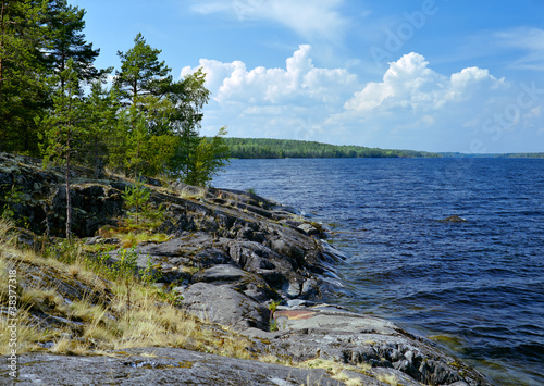 Cumulus clouds and stony shore of Ladoga lake photo