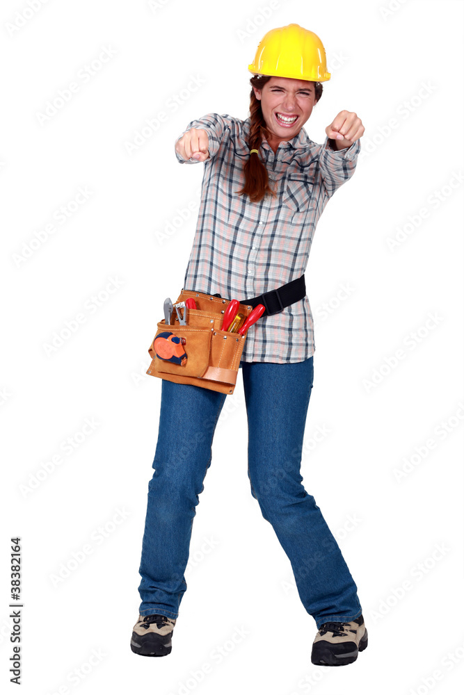 Tradeswoman gripping an invisible object and squinting Tradeswoman gripping an invisible object and squinting