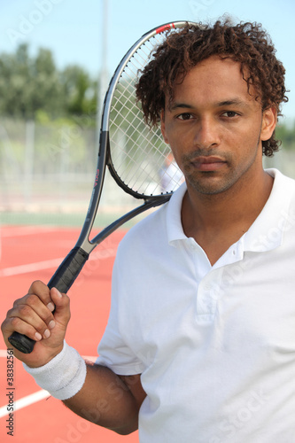 Tennis player holding racket © auremar
